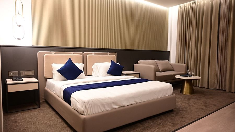 image of the bedroom at club charholi, pune featuring a double bed in the middle of the room